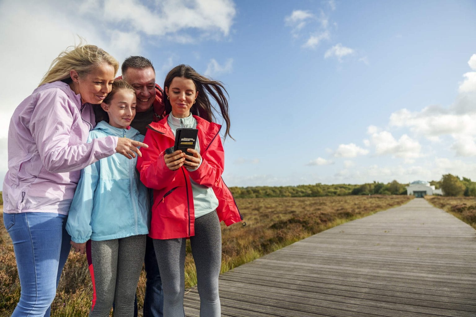 A picture of a family reading a brochure at an Irish attraction